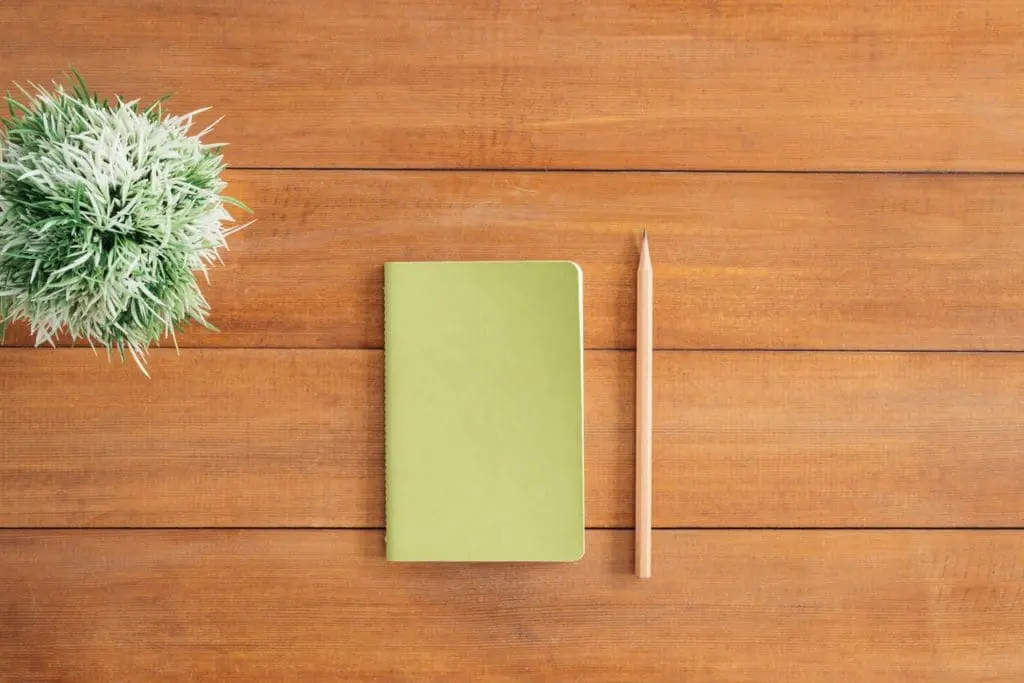 white notes beside a pencil on brown wooden surface 733854