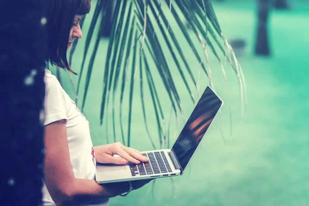 woman in white t shirt using macbook pro 2490916