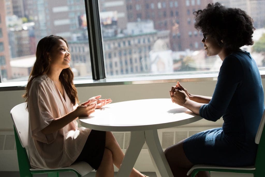 photography of women talking to each other 1181717 2