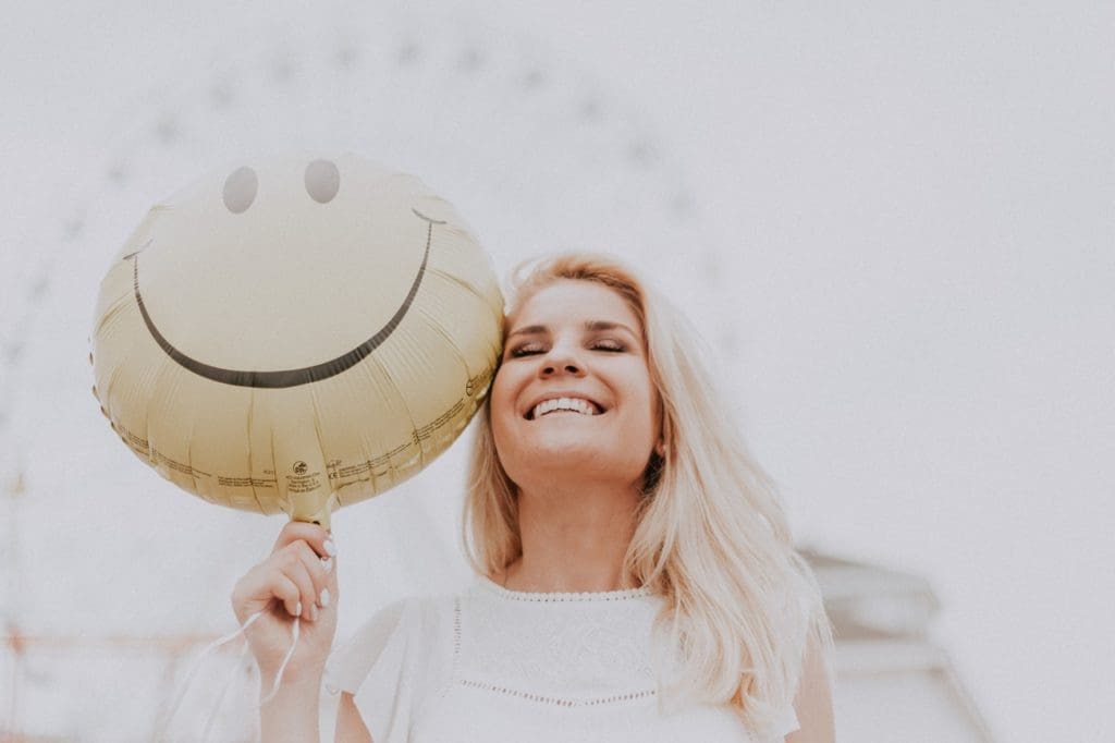 woman holding a smiley balloon 1236678