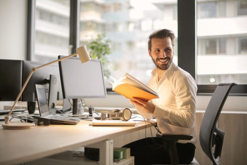 photo of man holding a book 927022 2