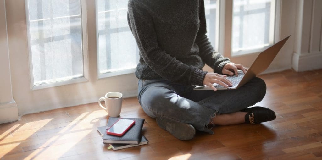 woman in gray sweat shirt sitting beside window 3759080